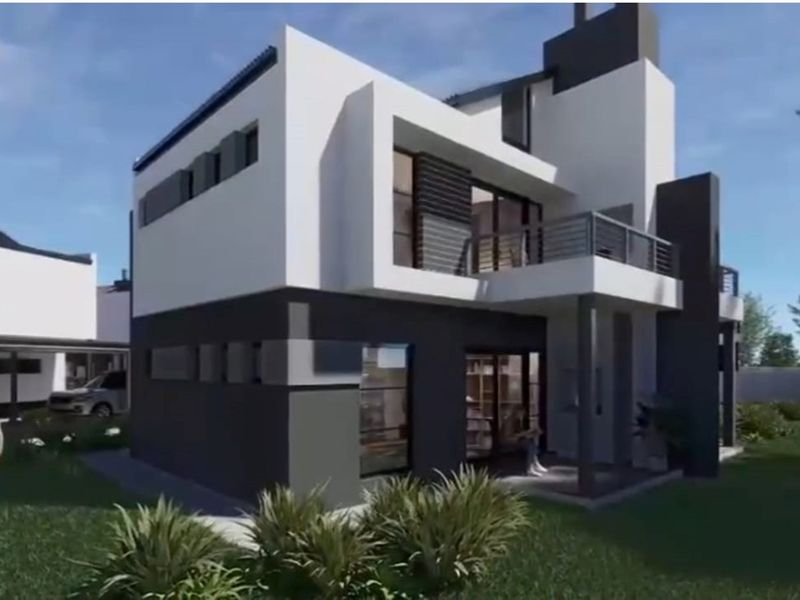 A modern two-story residential building featuring a contemporary architectural design with a balcony, clean lines, and a neutral color palette.