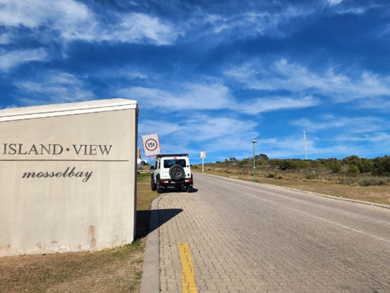 Entrance view of the Island View residential area in Mossel Bay, featuring paved roads and established signage.