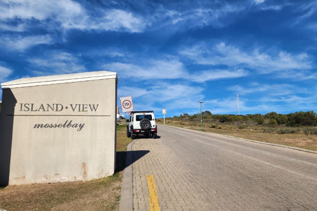 Entrance view of the Island View residential area in Mossel Bay, featuring paved roads and established signage.