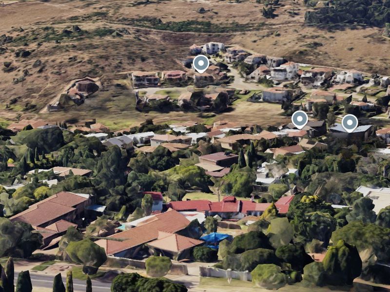 An aerial perspective of the residential neighborhood and surrounding landscape, showing the general layout and density of the area.