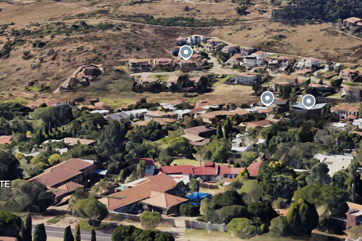 An aerial perspective of the residential neighborhood and surrounding landscape, showing the general layout and density of the area.