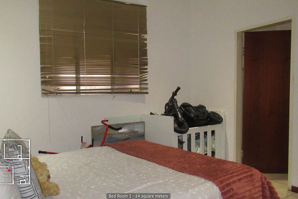 A bedroom featuring tiled flooring and venetian blinds, requiring minor repairs to window treatments and general cosmetic updates.