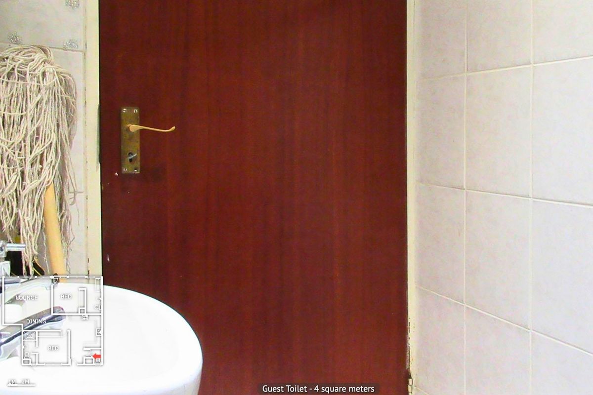 A small guest toilet featuring a pedestal basin and tiled walls, currently showing signs of wear and dated finishes.