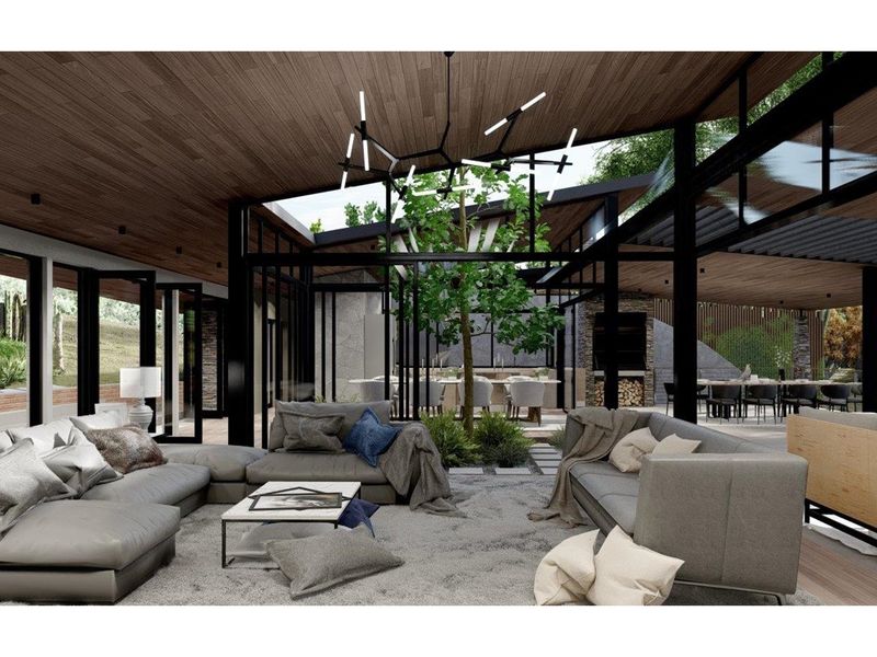 Spacious open-plan living area featuring high timber ceilings, floor-to-ceiling glass walls, and a central internal courtyard with integrated greenery.