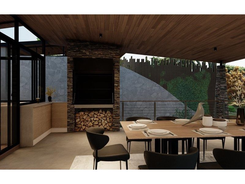 A modern covered patio featuring a built-in stone fireplace, wood-paneled ceiling, and sleek architectural finishes, ideal for outdoor dining and entertaining.