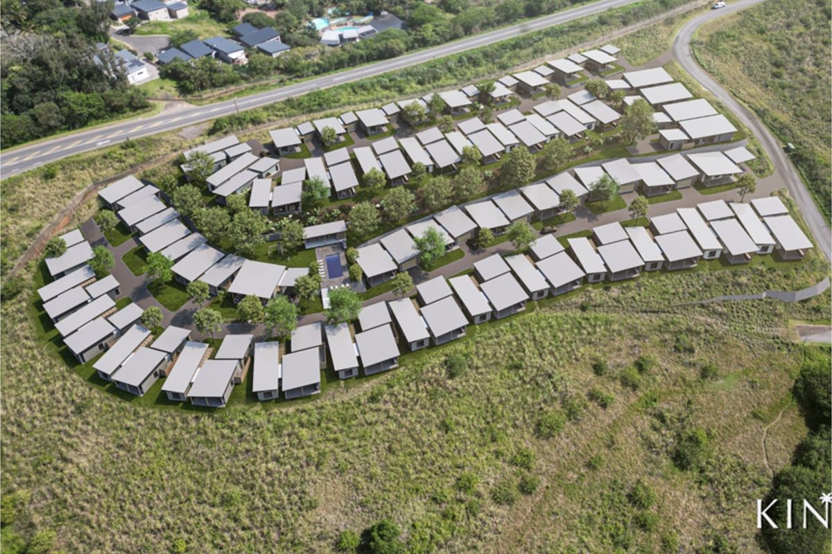 Aerial view of a modern residential estate development featuring multiple housing units, landscaped grounds, and a communal swimming pool.