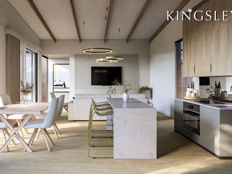 Modern open-plan living area featuring exposed timber beams, a sleek kitchen with stone island, and a contemporary slatted feature wall.