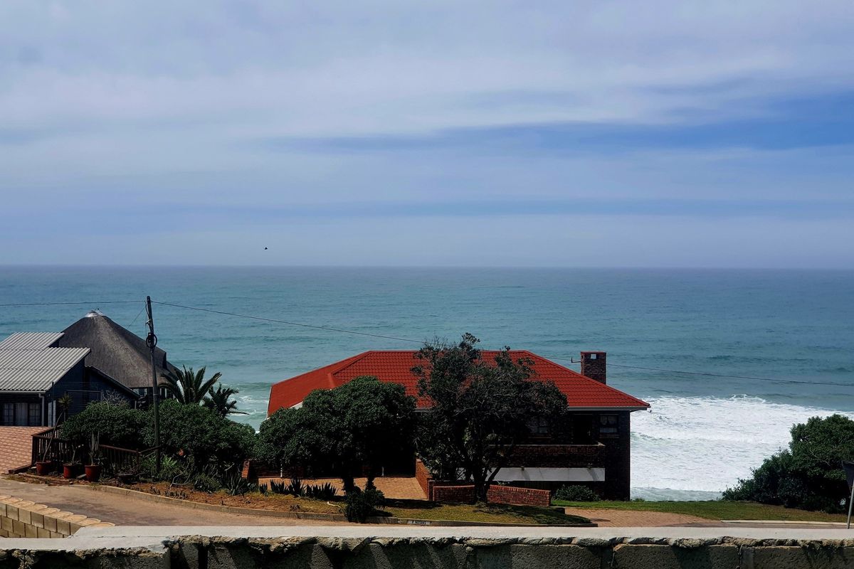 A scenic elevated view overlooking the ocean and coastal landscape, showcasing the property's prime location and natural surroundings.