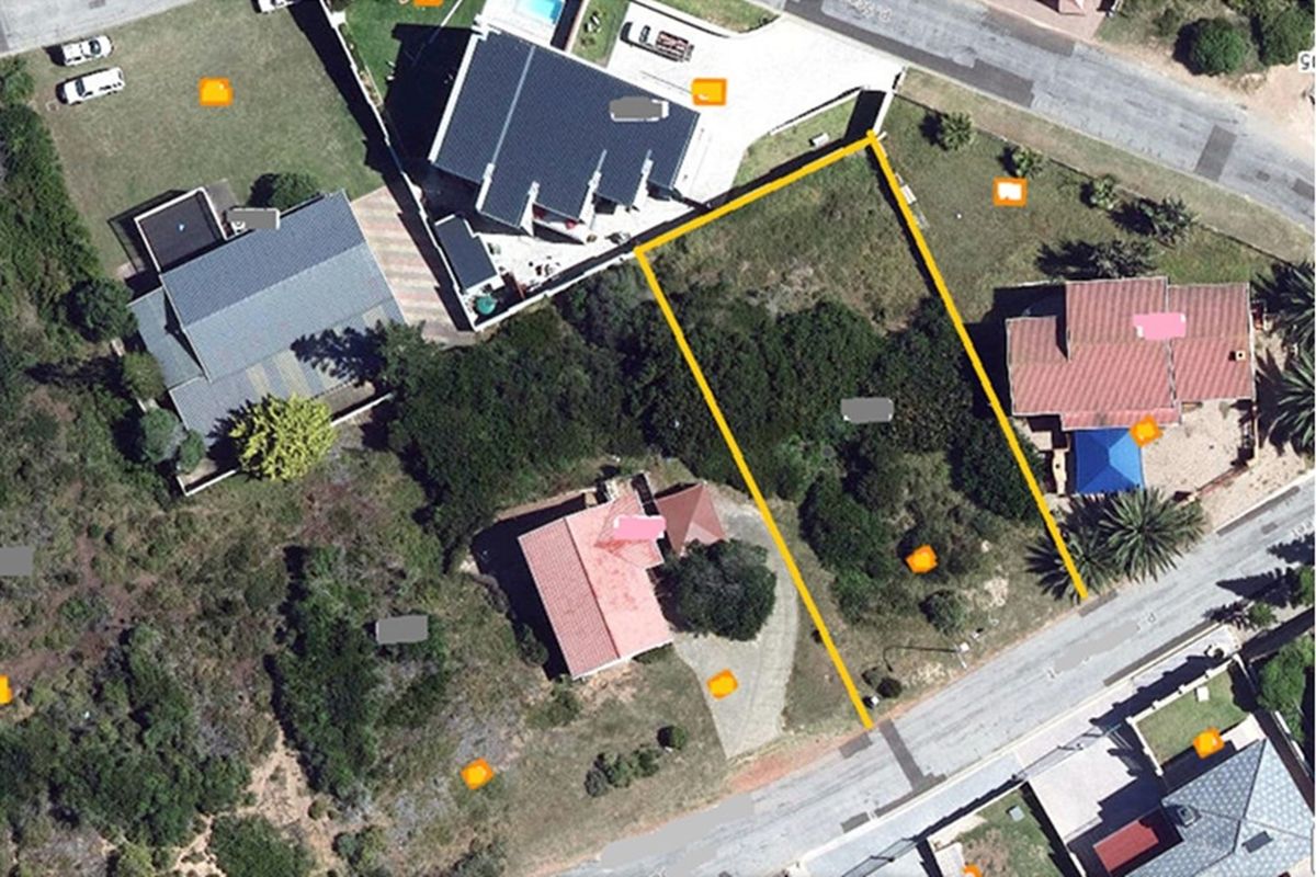 An aerial view of a vacant residential land plot, highlighting its boundaries and surrounding neighborhood context.