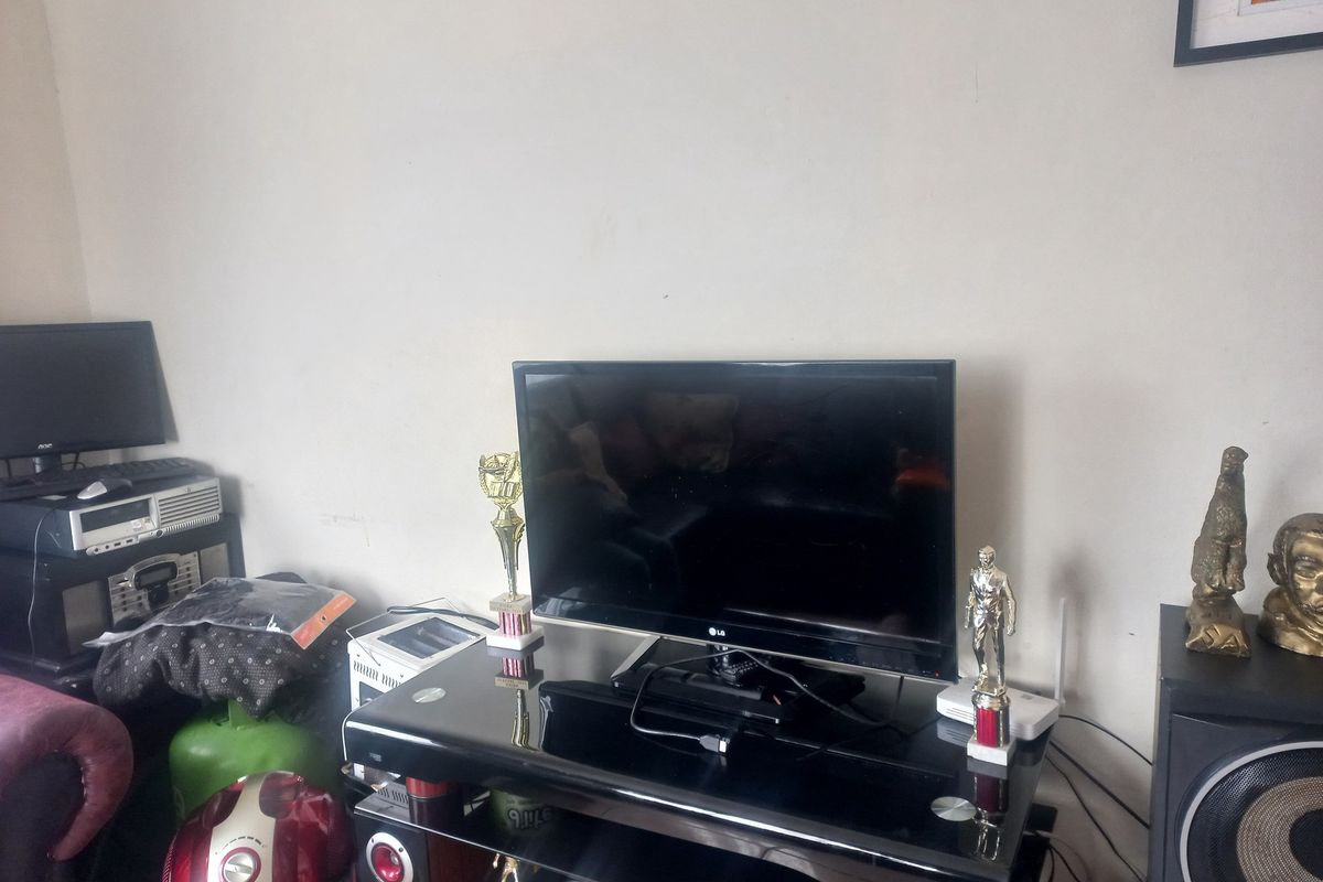 A living room area featuring plain wall finishes, suitable for personalization and interior design updates.
