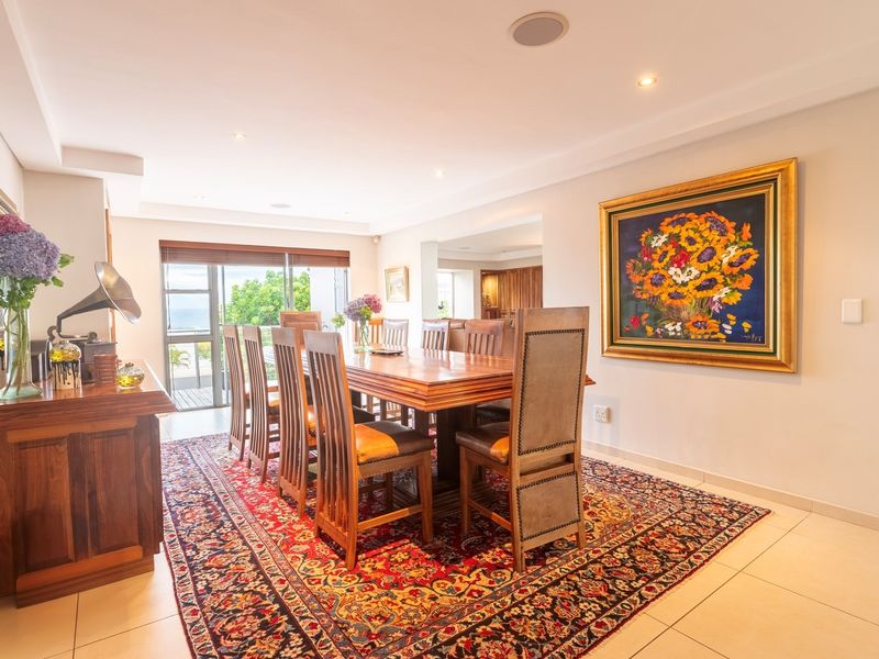 Spacious dining room featuring tiled flooring, recessed lighting, and a sliding glass door providing natural light and access to the outdoor area.