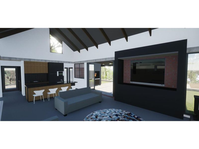 A modern open-plan living and kitchen area featuring vaulted ceilings, exposed beams, and a contemporary built-in media wall.