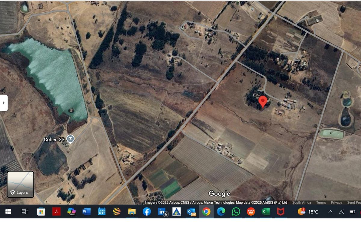 An aerial satellite view of the farm property and surrounding rural landscape, showing access roads and nearby water features.