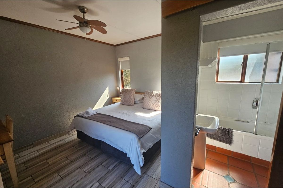 A bedroom featuring a ceiling fan and an en-suite bathroom with a bathtub and pedestal basin.