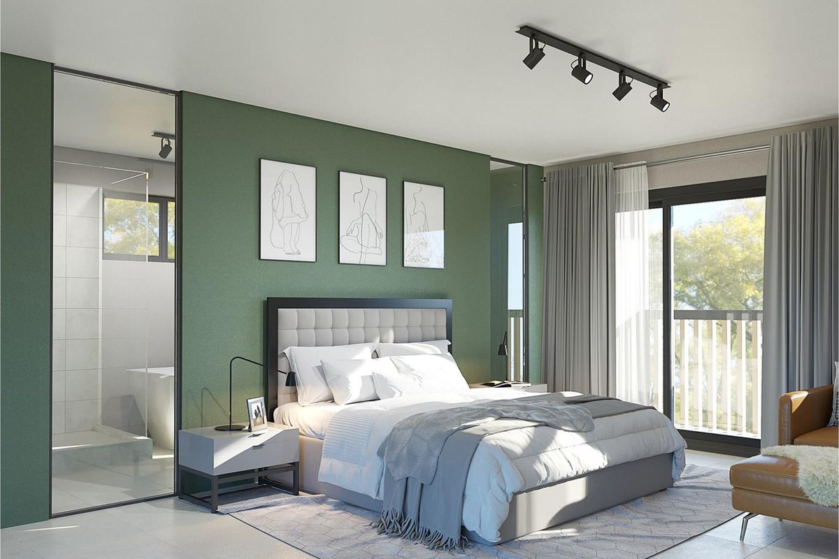 Modern bedroom featuring an en-suite bathroom with glass partition, track lighting, and sliding door access to a private balcony.