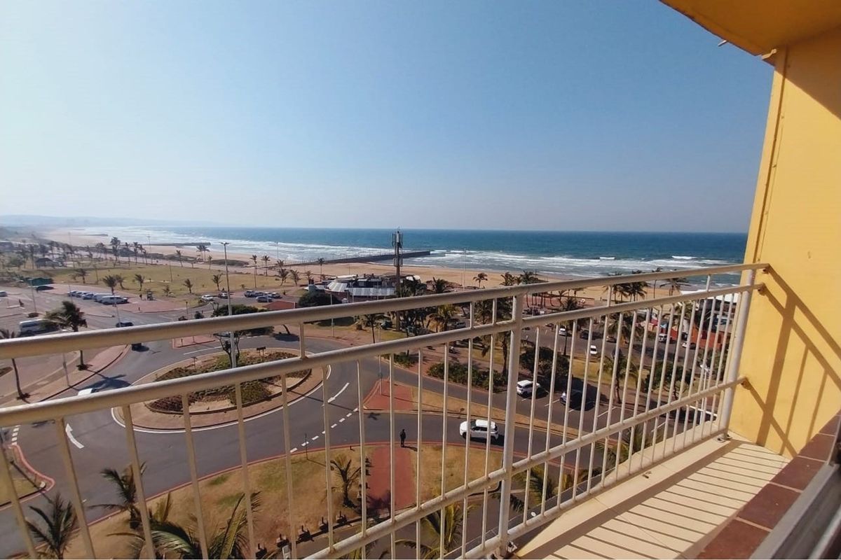 Elevated balcony offering expansive panoramic views of the coastline, beach, and surrounding urban landscape.