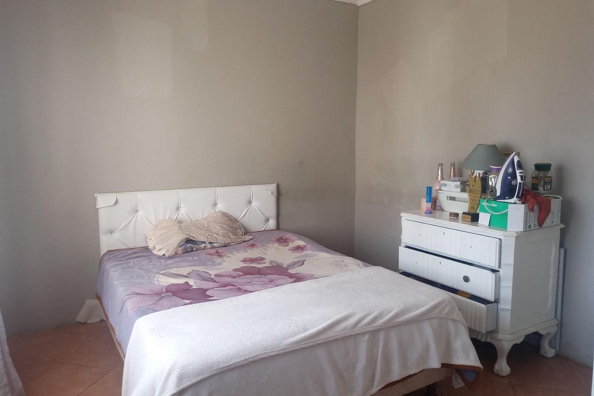 A bedroom featuring tiled flooring and neutral wall paint, offering a blank canvas for personalization and interior updates.