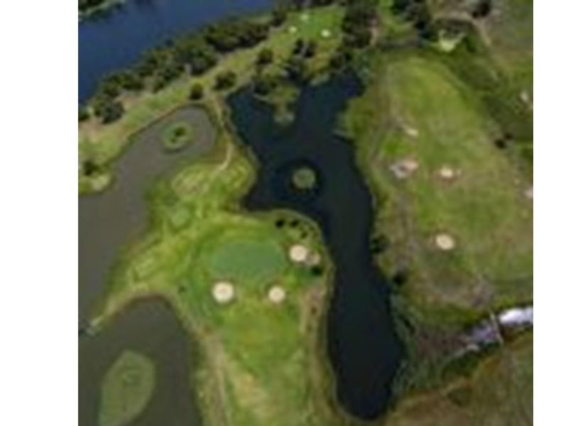 An aerial view of the residential land parcel, showcasing the surrounding landscape, natural water features, and green space.