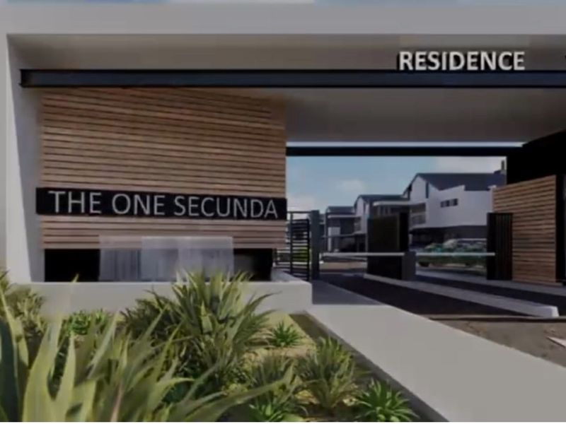 Modern gated entrance to The One Secunda residential complex, featuring contemporary architectural design, timber cladding, and secure access control.
