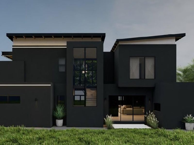 A modern, dark-toned architectural exterior featuring large glass windows, sliding doors, and clean lines, showcasing a contemporary residential design.
