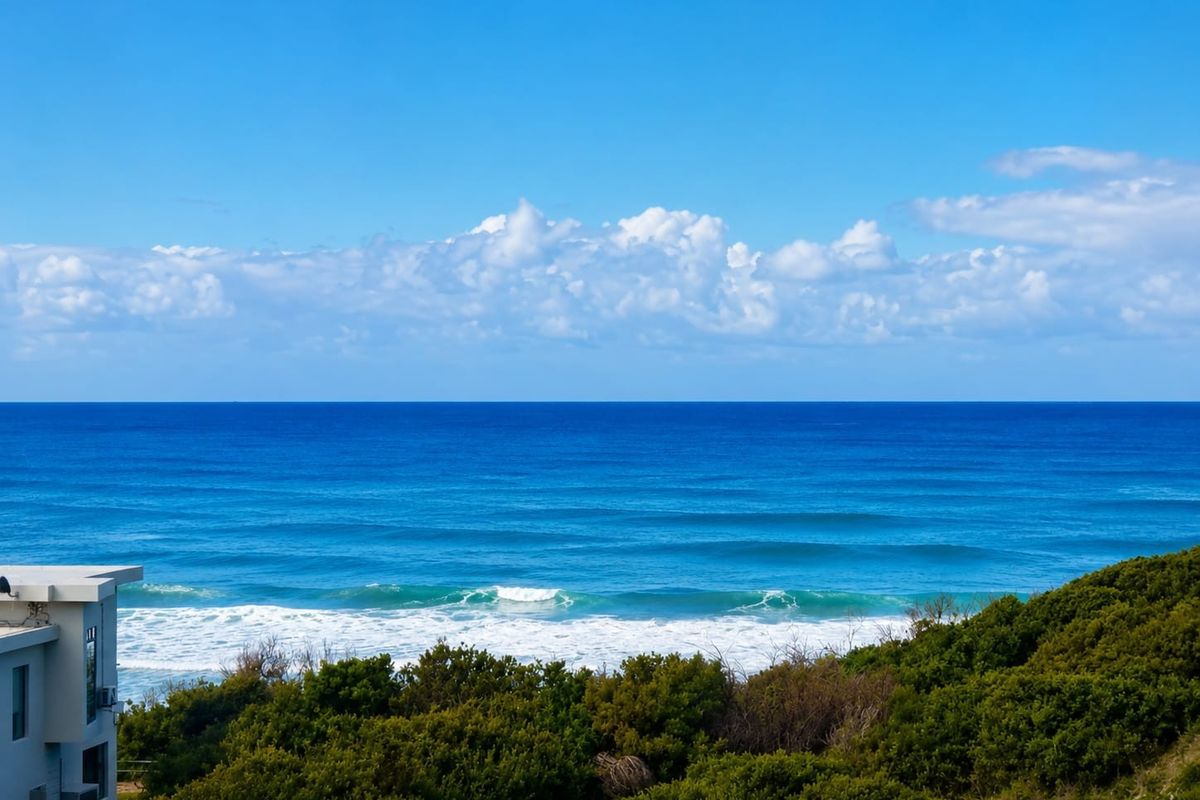 A scenic, elevated view of the ocean and coastline, showcasing the property's prime coastal location.