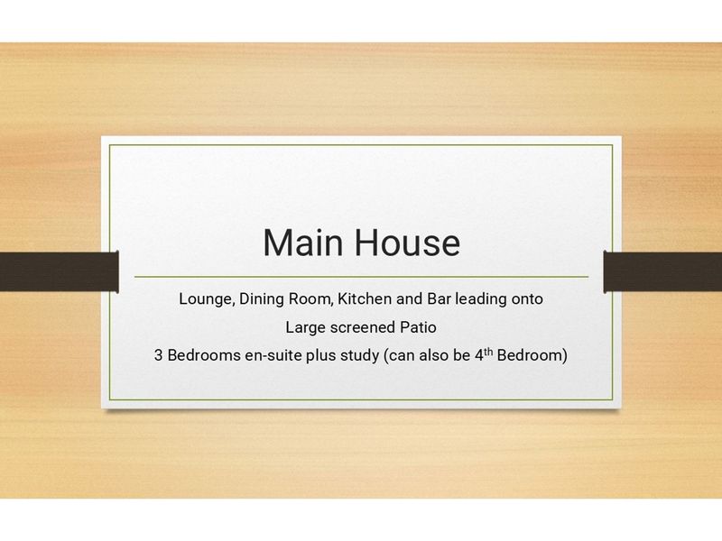 A descriptive text slide outlining the key features and layout of the main house, including living areas, patio, and bedroom configuration.