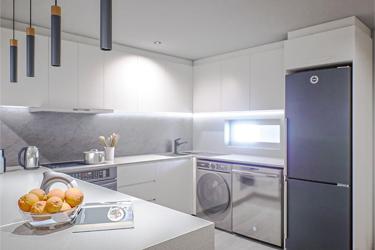 Modern kitchen featuring sleek white cabinetry, stone countertops, integrated appliances, and contemporary pendant lighting.