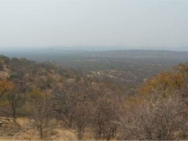 Expansive landscape view overlooking the natural bushveld and surrounding terrain, showcasing the property's scenic rural setting.