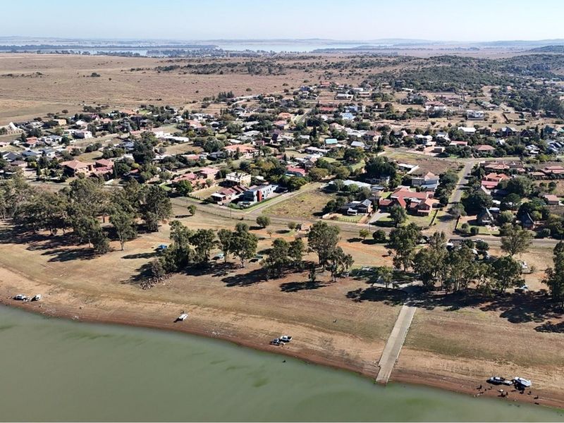 Aerial view of the residential area showing the waterfront, boat ramp access, and surrounding landscape.
