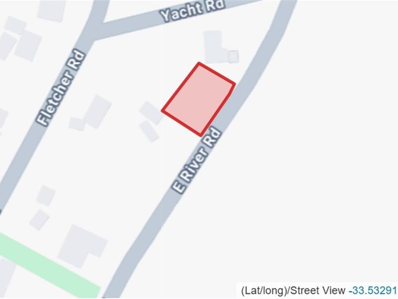 A map view highlighting the vacant residential land parcel located at the corner of E River Road and Yacht Road.