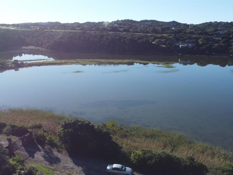 An elevated aerial view showcasing the expansive lagoon and surrounding natural landscape, highlighting the scenic waterfront location of the property.