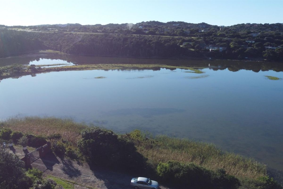 An elevated aerial view showcasing the expansive lagoon and surrounding natural landscape, highlighting the scenic waterfront location of the property.