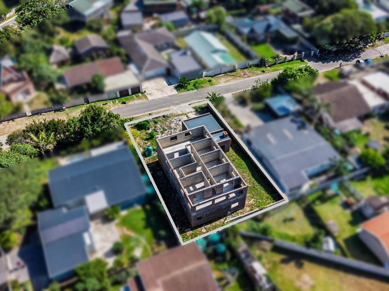 Aerial view of a residential property currently under construction, showing the structural brickwork and layout of the building on the plot.