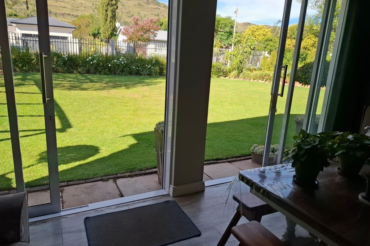 Bright living area featuring large sliding glass doors that provide seamless access to the rear garden and patio space.