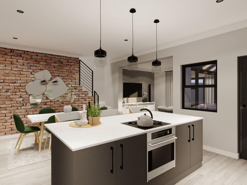 Modern open-plan living area featuring a central kitchen island with built-in appliances, pendant lighting, and a striking exposed brick feature wall.