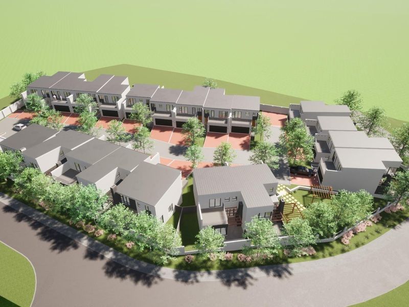 An aerial 3D architectural rendering of a modern residential housing complex featuring multiple units, paved driveways, and landscaped communal areas.