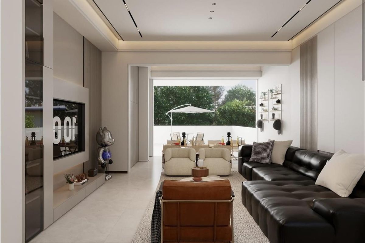 Modern open-plan living area featuring sleek integrated cabinetry, recessed ceiling lighting, and large sliding doors leading to an outdoor patio space.