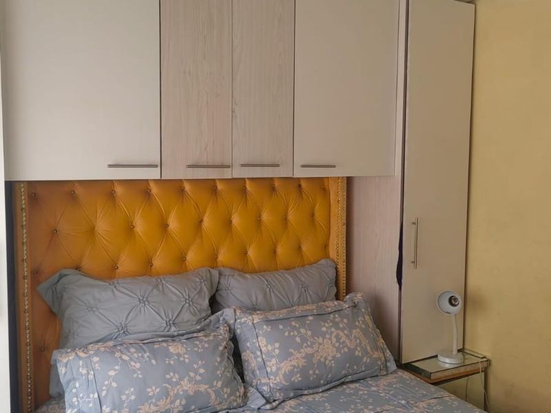 Bedroom featuring built-in cabinetry and a tongue and groove ceiling finish.