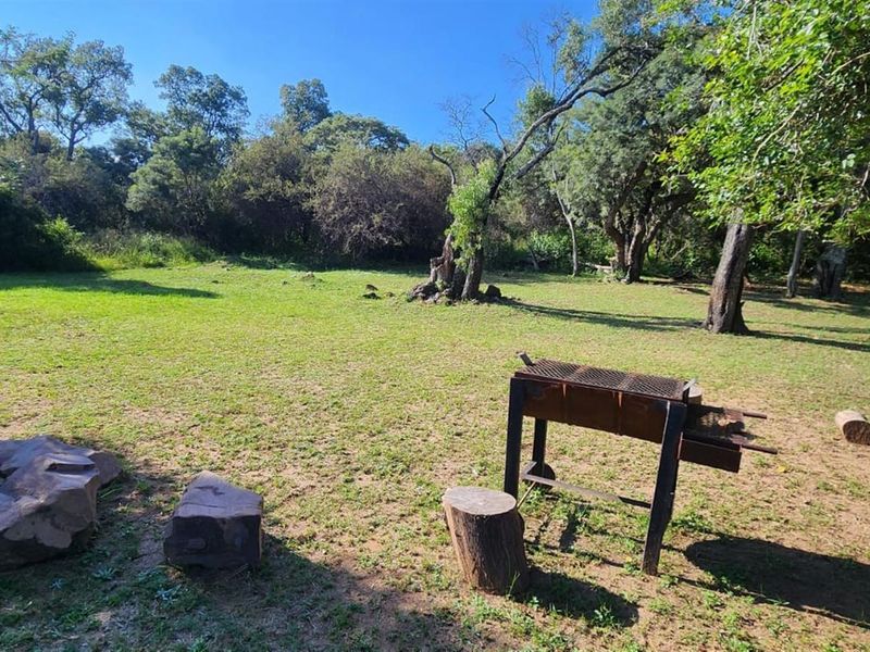A spacious, level residential plot featuring established trees and natural landscaping, offering a peaceful setting for future development.