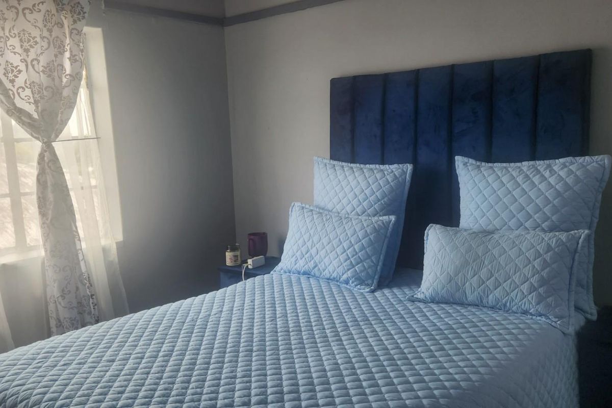 A cozy bedroom featuring a window with natural light, providing a comfortable and functional sleeping space.