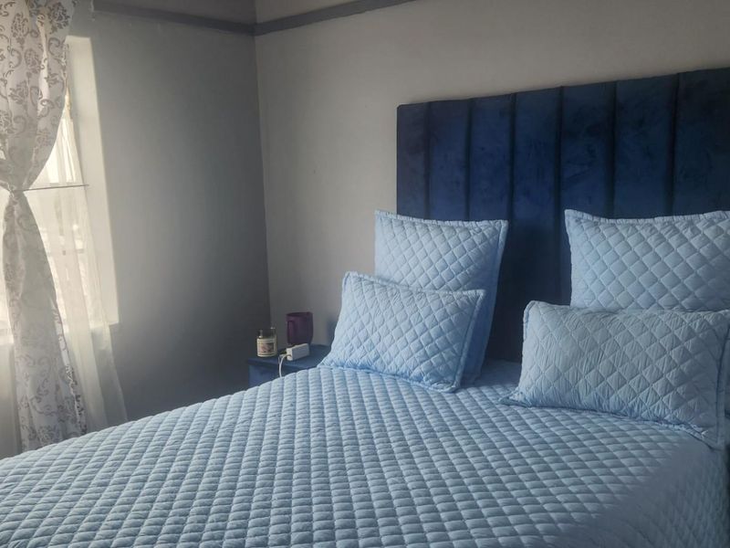 A cozy bedroom featuring a window with natural light, providing a comfortable and functional sleeping space.