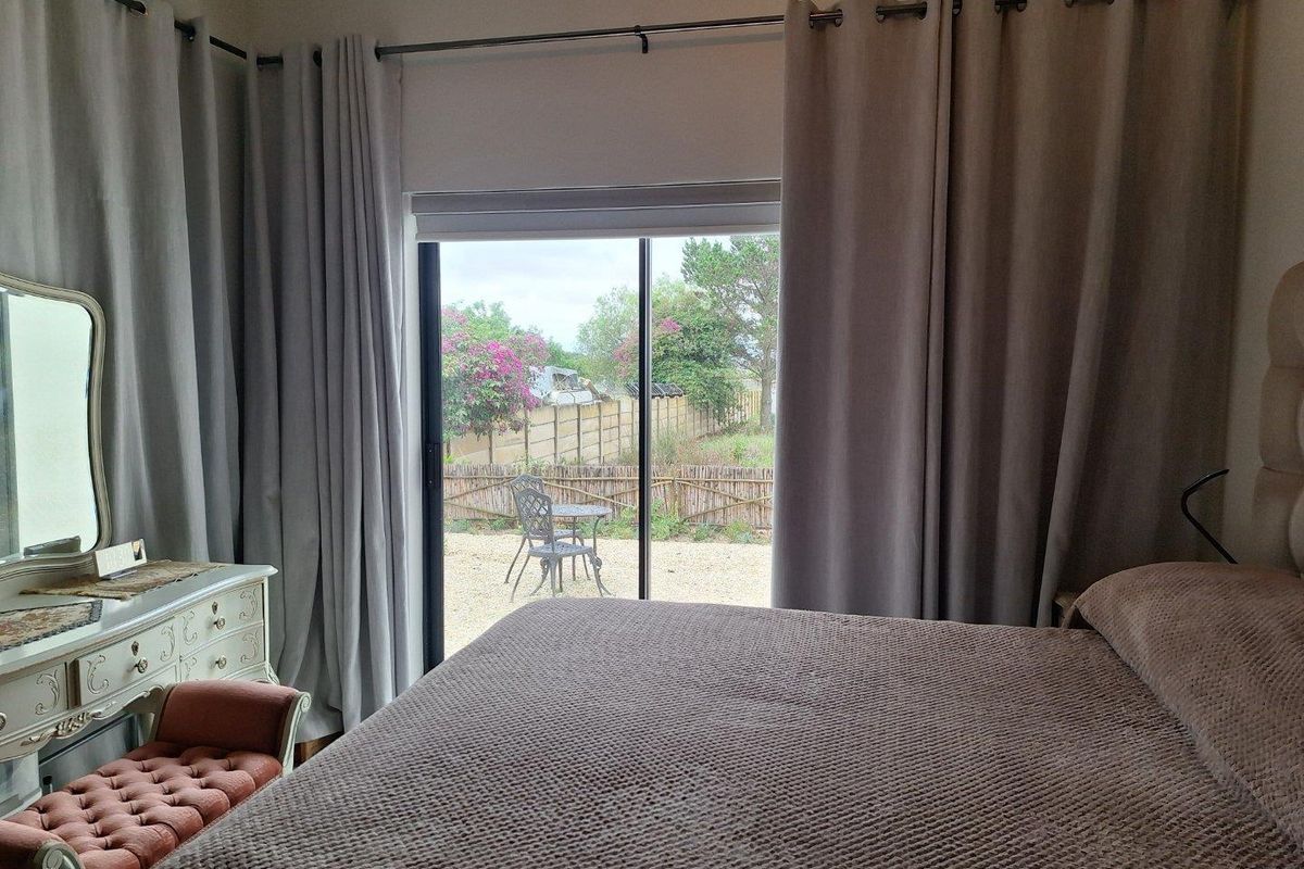Bedroom featuring sliding glass doors that provide direct access to the rear garden area.