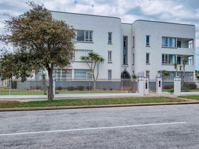 Front elevation of the Clencarry Court apartment building, featuring a secure perimeter fence and established exterior facade.