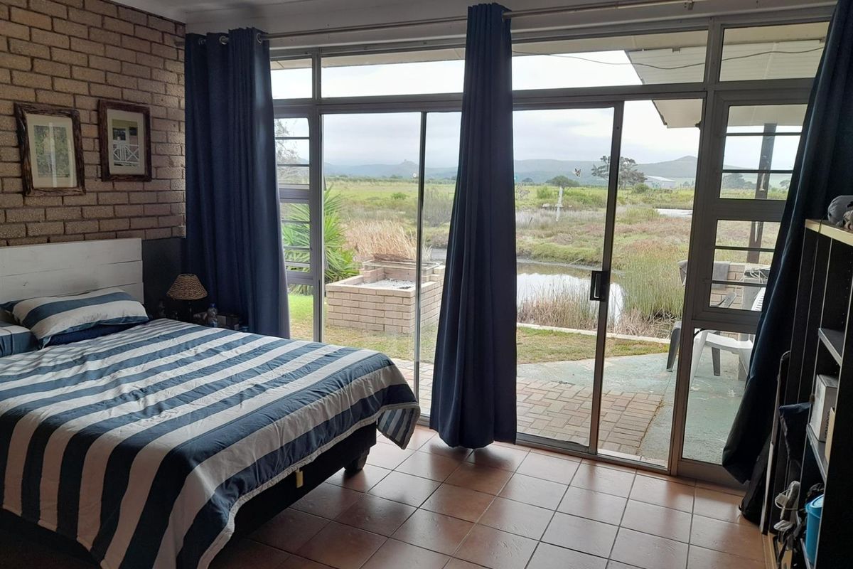 Bedroom featuring large sliding glass doors that open to a patio area with scenic views of the surrounding landscape.