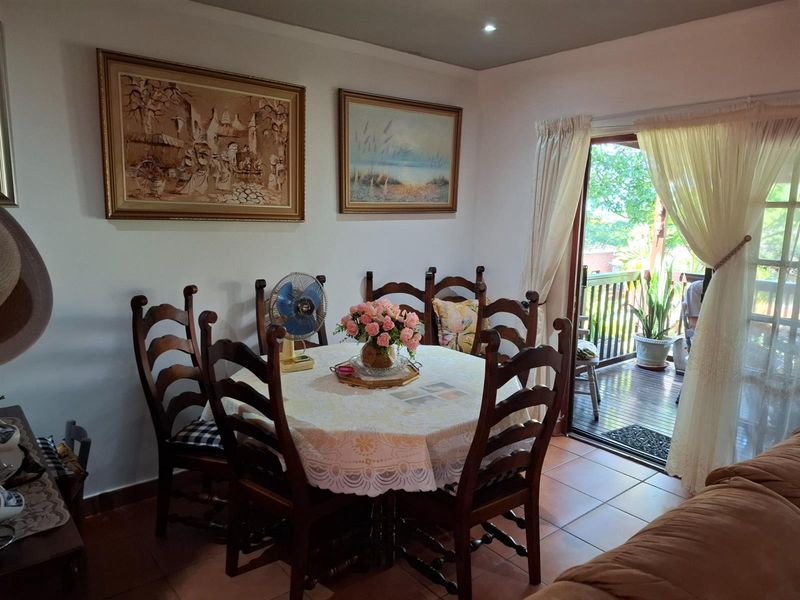 Dining area featuring tiled flooring and direct access to an outdoor balcony through a sliding glass door.
