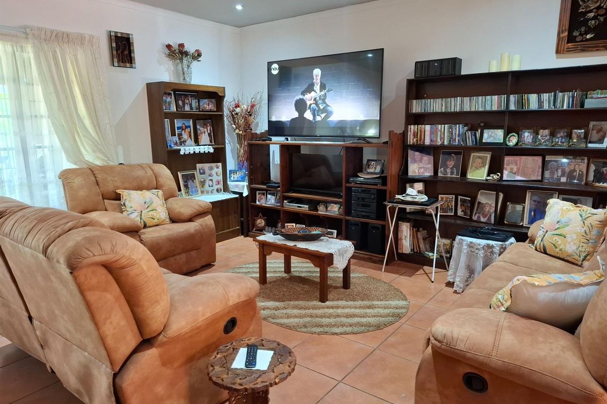 A comfortable living room featuring tiled flooring and recessed ceiling lighting, providing a functional space for relaxation and entertainment.