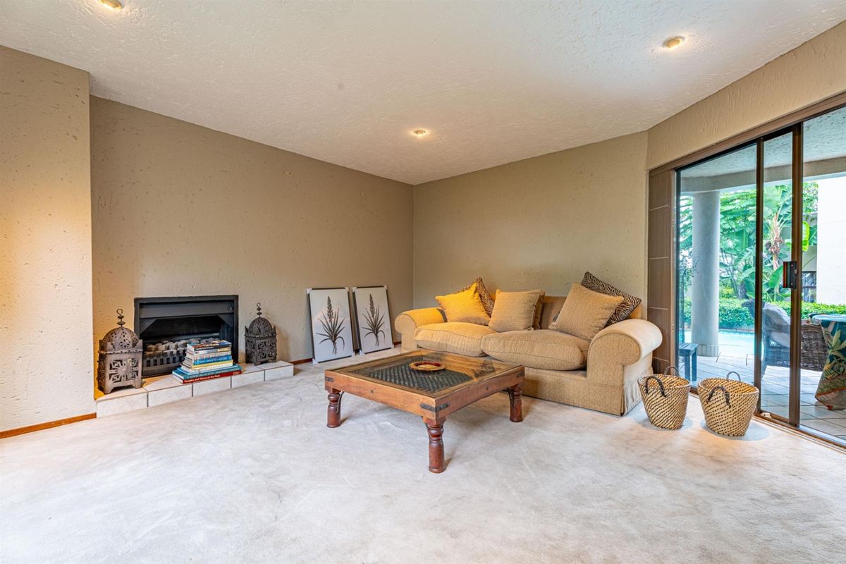 A comfortable living room featuring a built-in fireplace and large sliding glass doors that provide direct access to the outdoor patio area.