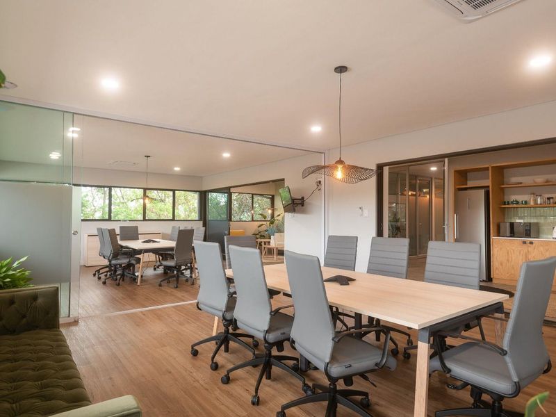 Modern commercial office space featuring glass partitions, open-plan layout, integrated kitchenette, and high-quality finishes throughout.
