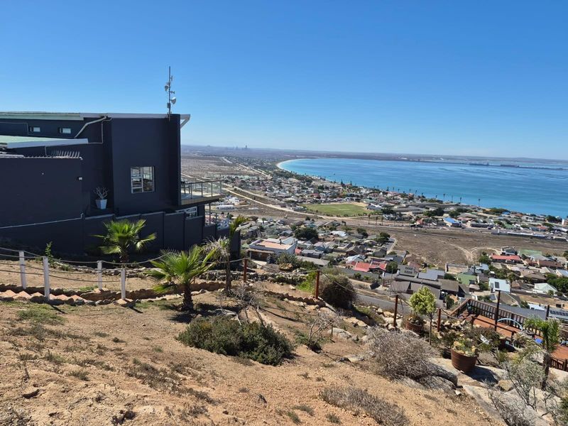 Elevated coastal view overlooking the town, bay, and surrounding landscape from the property's hillside position.