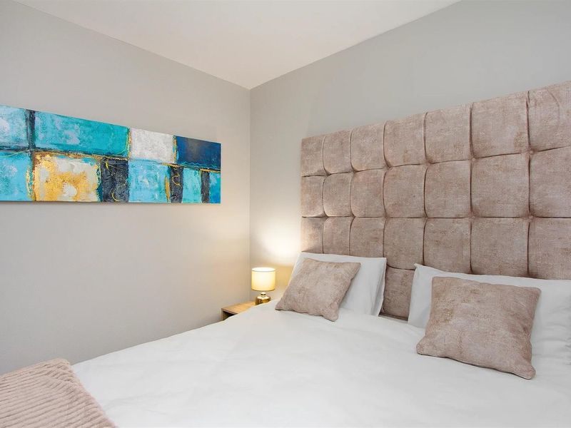A well-maintained bedroom featuring neutral wall tones and a clean, modern aesthetic.